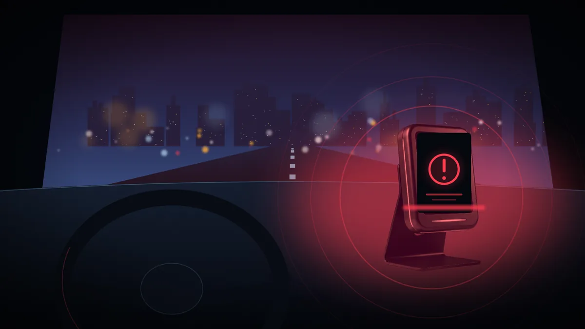 The driver display in the cabin glowing red with a safety alert